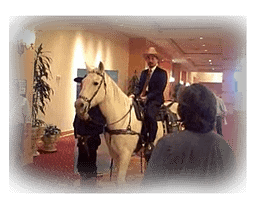 Roger Nishi at the 2008 OPASTCO Winter Conference on a horse with a cowboy hat.