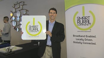 Kurt Gruendling of WCVT displaying one of the NTCA Smart Rural Community Award road signs.