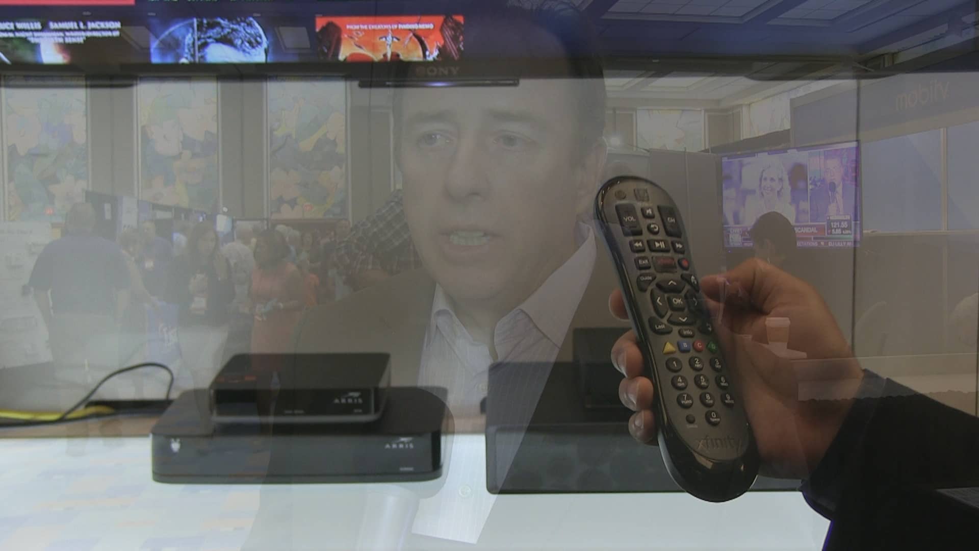 Rich Fickle and a remote control which depicts the increasing amount of consumer choice in the video market.
