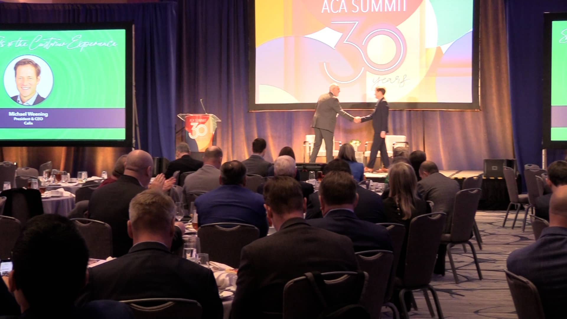 Michael Weening of Calix on stage with John Higginbotham of ACA Connects at the ACA Summit.